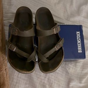 Cross toe strapped Birkenstocks